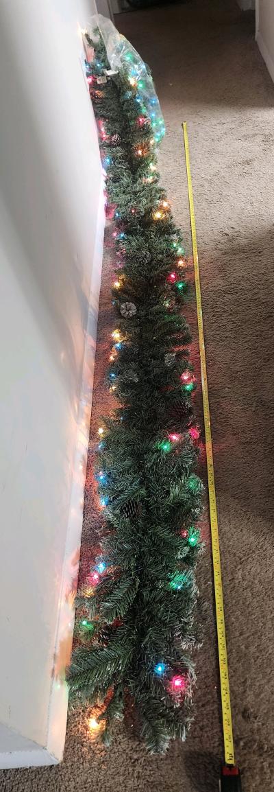 Realistic 9ft flocked garland w multi lights and pinecones