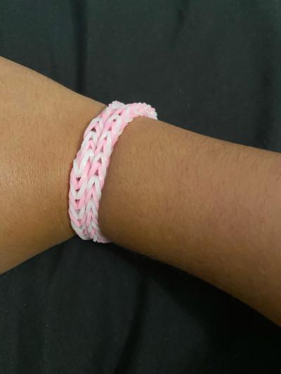 a two braclets that are white and pink