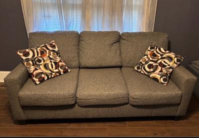 gray couch and designer chair