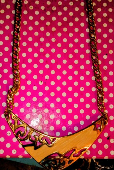Gold Tone Necklace with a gold and pink and black shell pend
