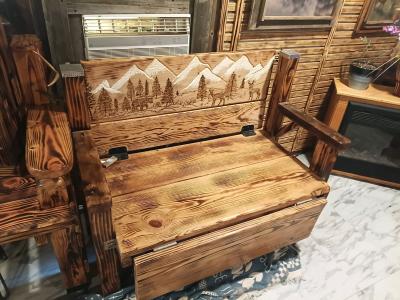 wood bench with hand carved picture on the back