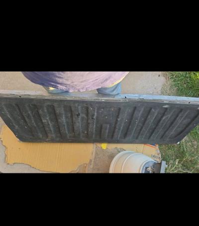 Silver GMC tailgate with minor dent - Thumbnail 3