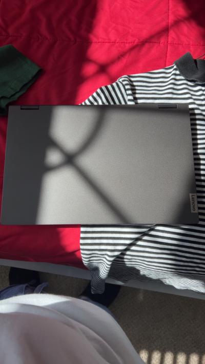 computer and  shirts and shoes and charger